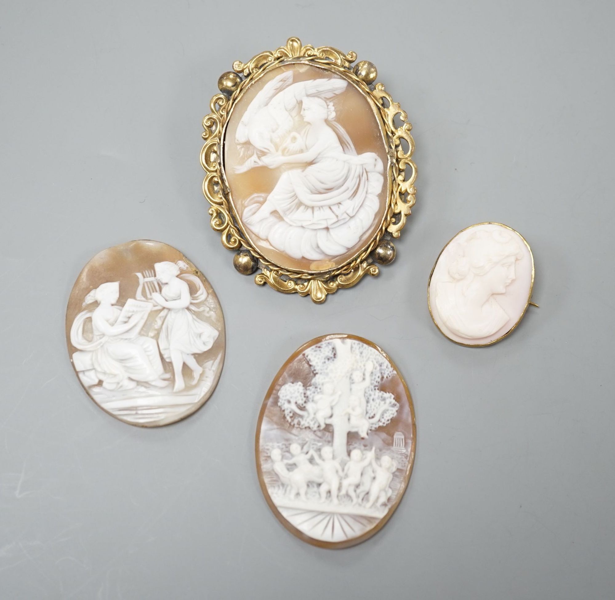 Two gilt metal mounted carved oval cameo shell cameos, largest 63mm and two similar unmounted cameos.